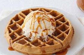 vanilla ice cream on a waffle with chocolate or caramel
